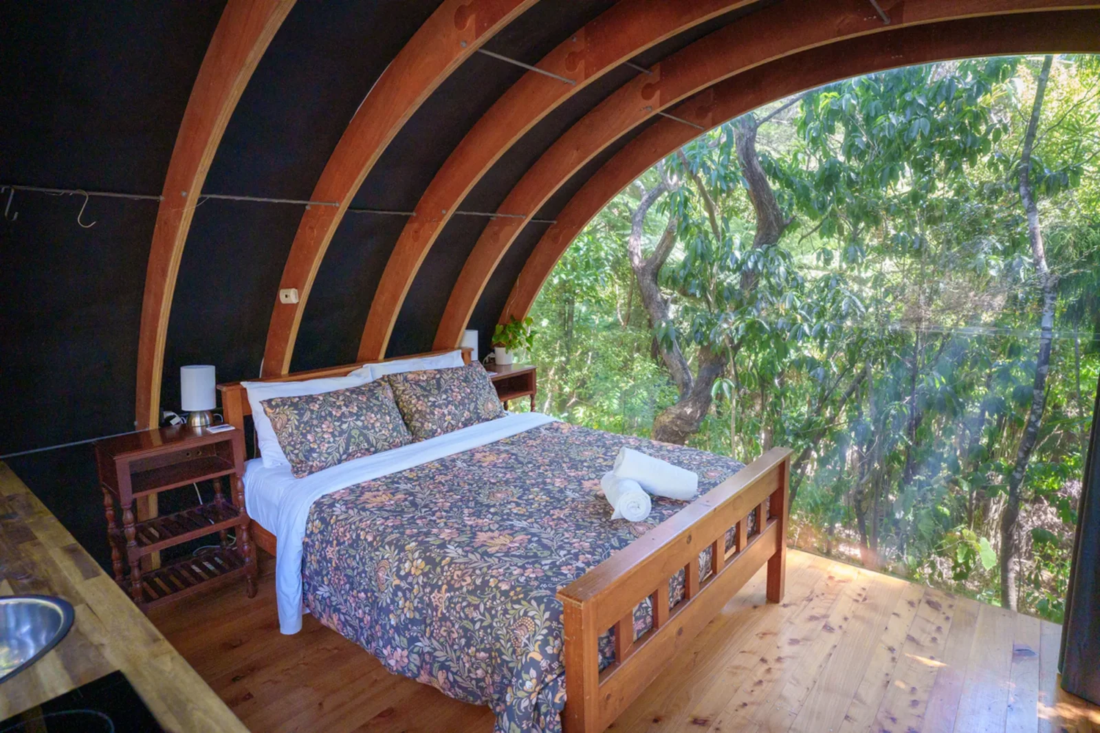 Bedroom with arched wooden ceiling in the Forest Cabin at Totara Enclave