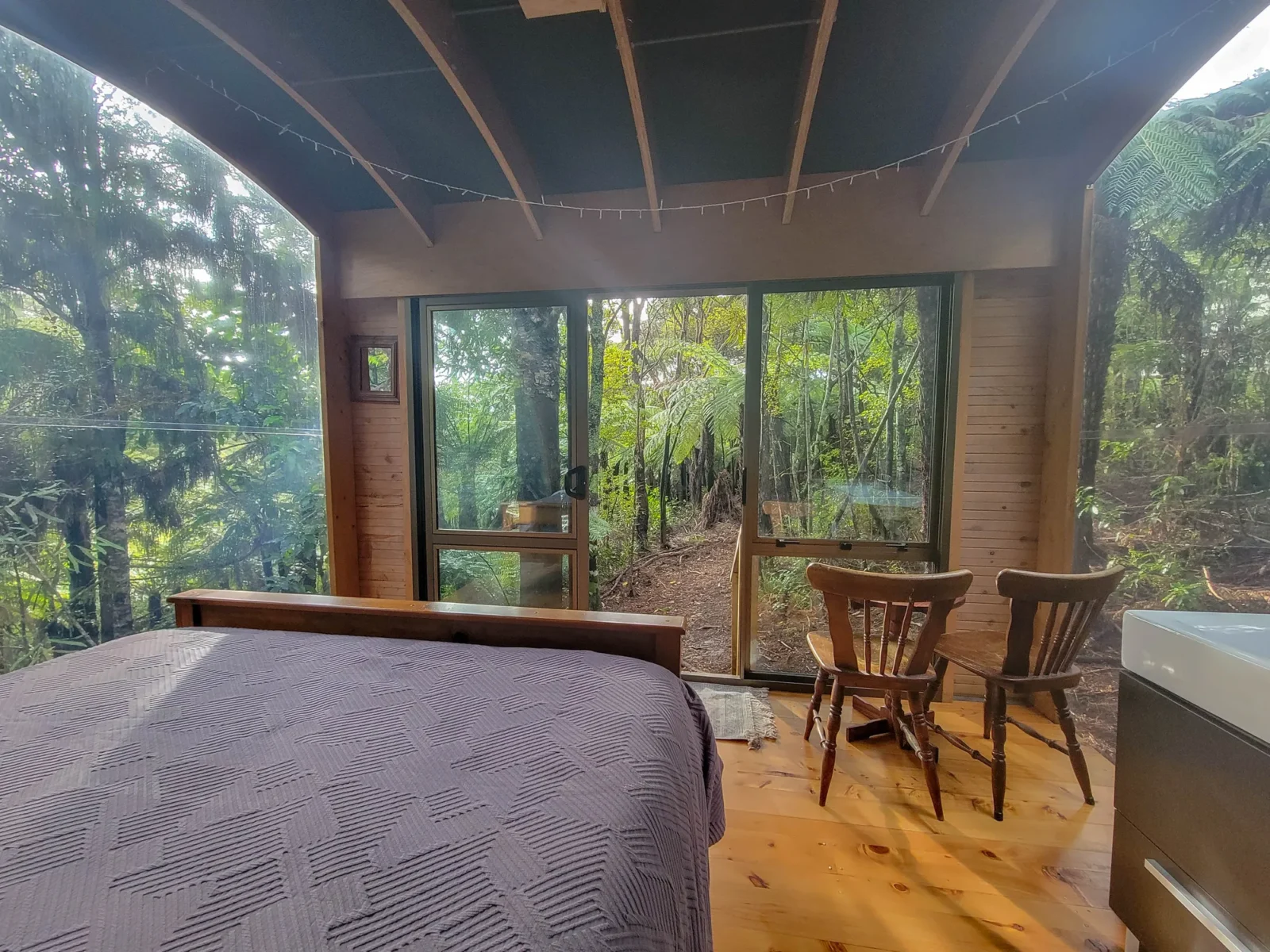 Dining area with forest views in the Forest Cabin at Totara Enclave
