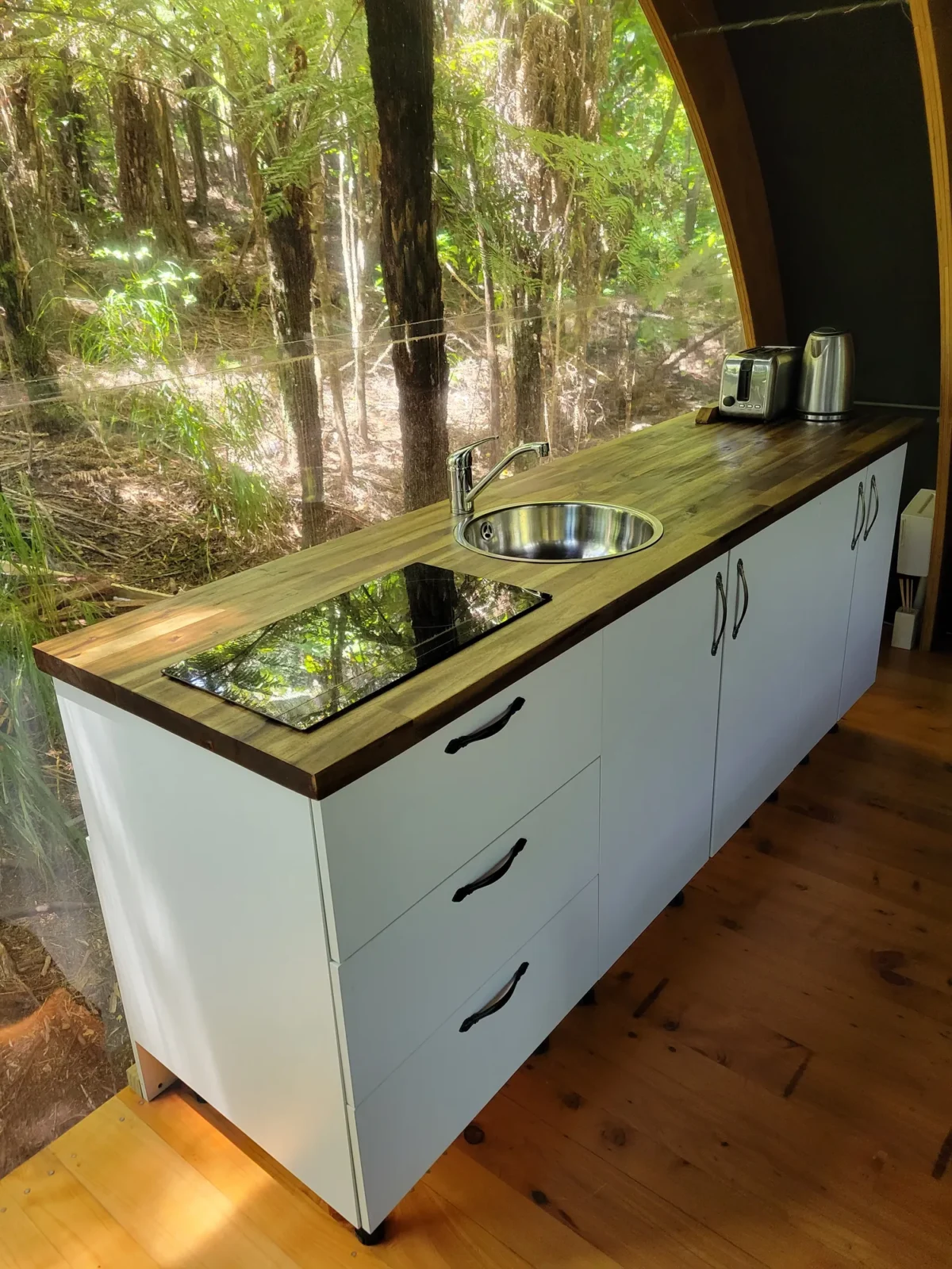 "Kitchen with timber benchtop in the Forest Cabin at Totara Enclave