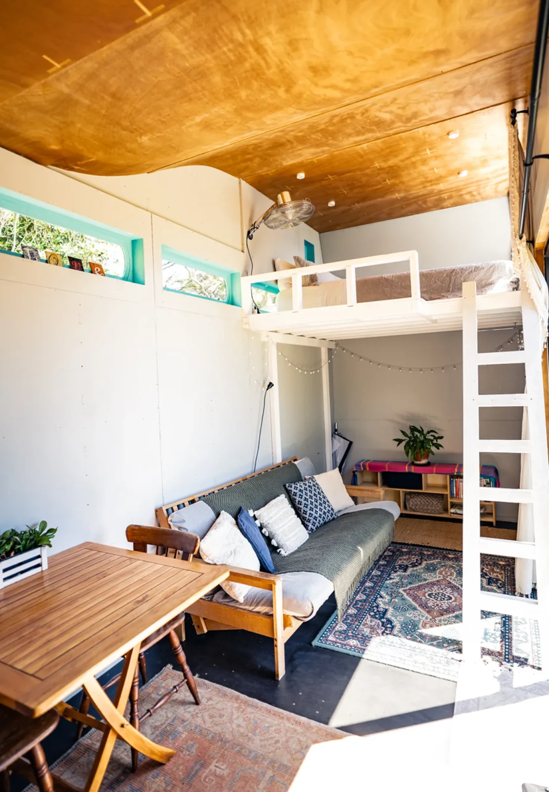 Loft bunk bed and living area in Kauri cabin at Totara Enclave