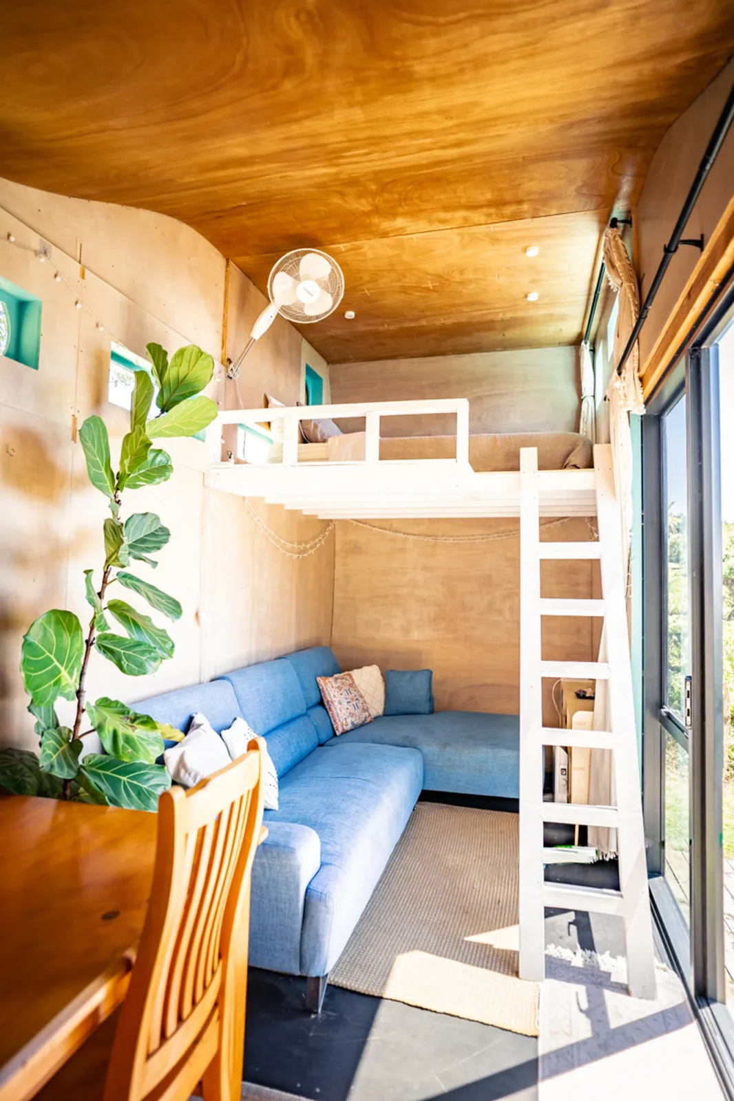 Loft bunk bed and living area in Kowhai cabin at Totara Enclave