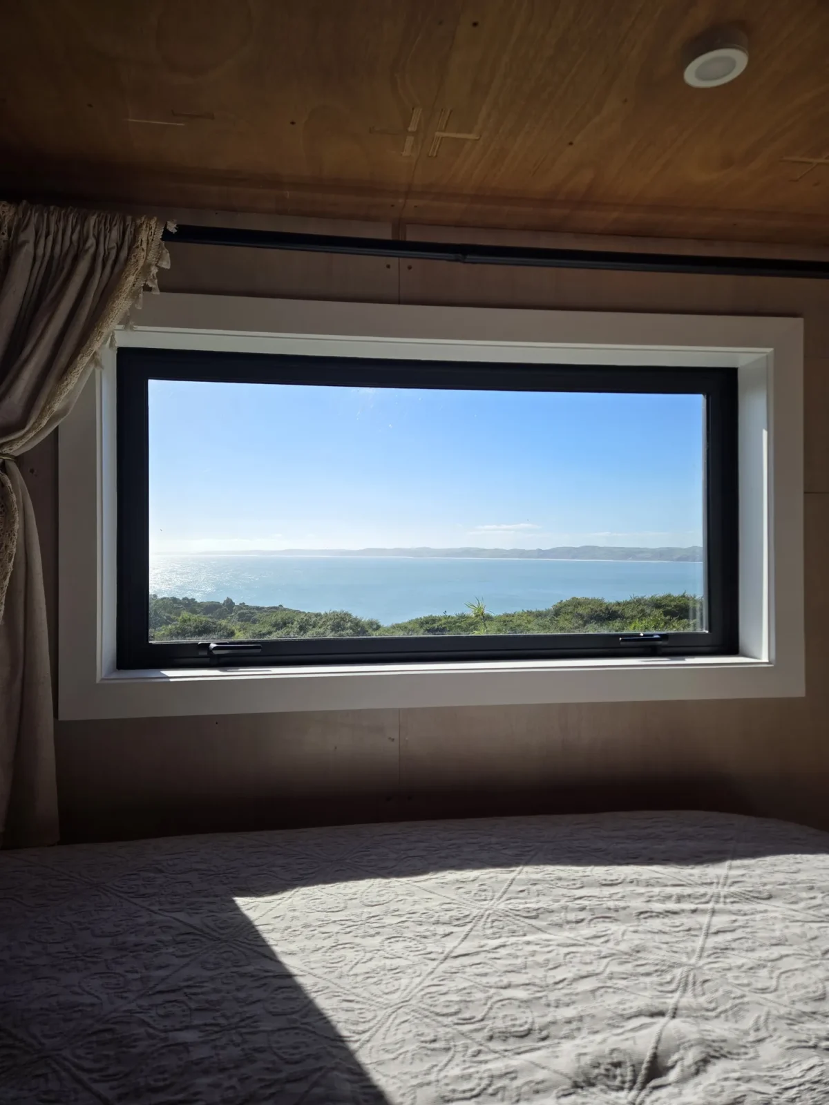 Picture window with ocean views in Kowhai cabin at Totara Enclave