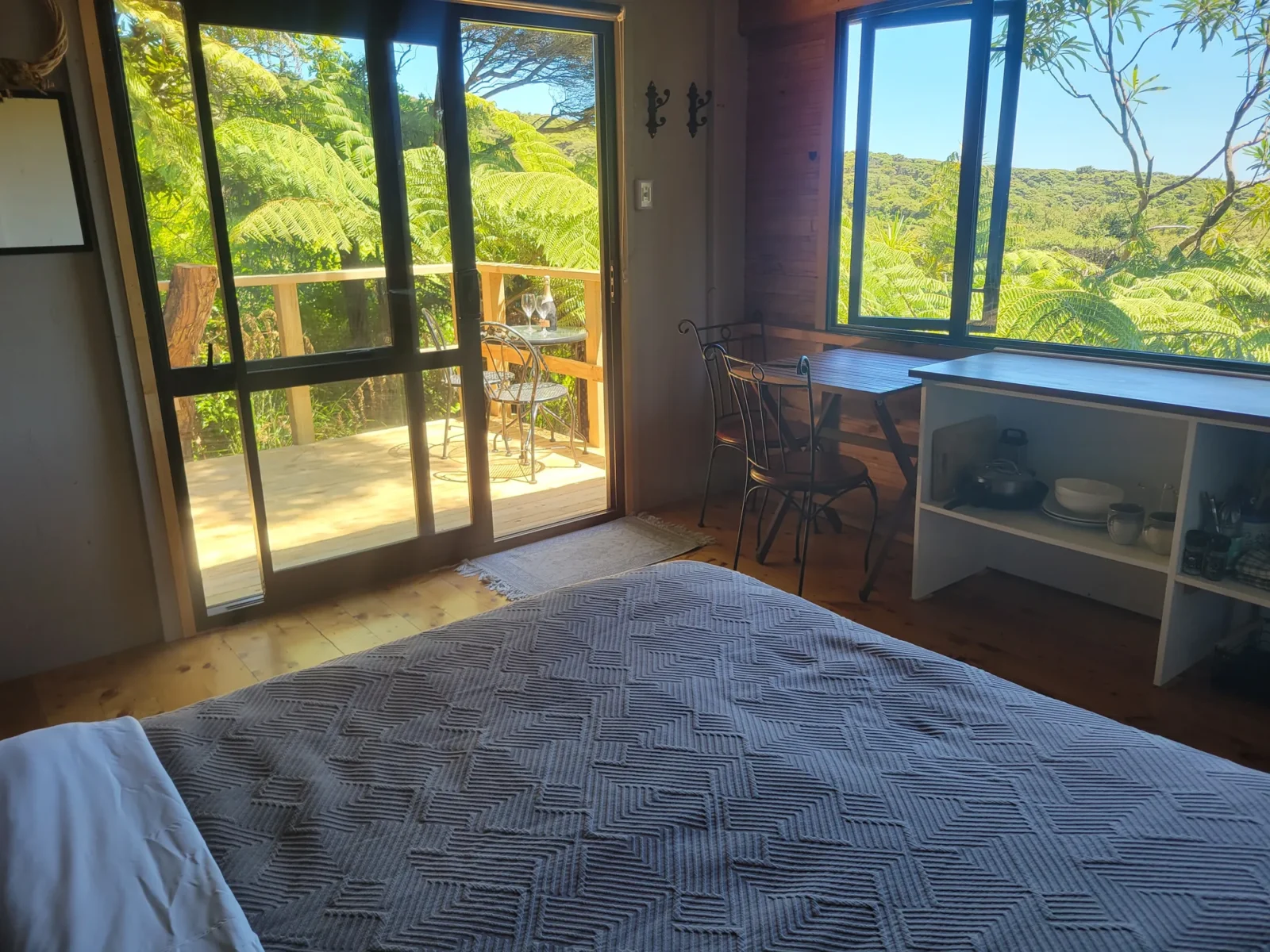 Bedroom with garden views in The Outpost cabin at Totara Enclave
