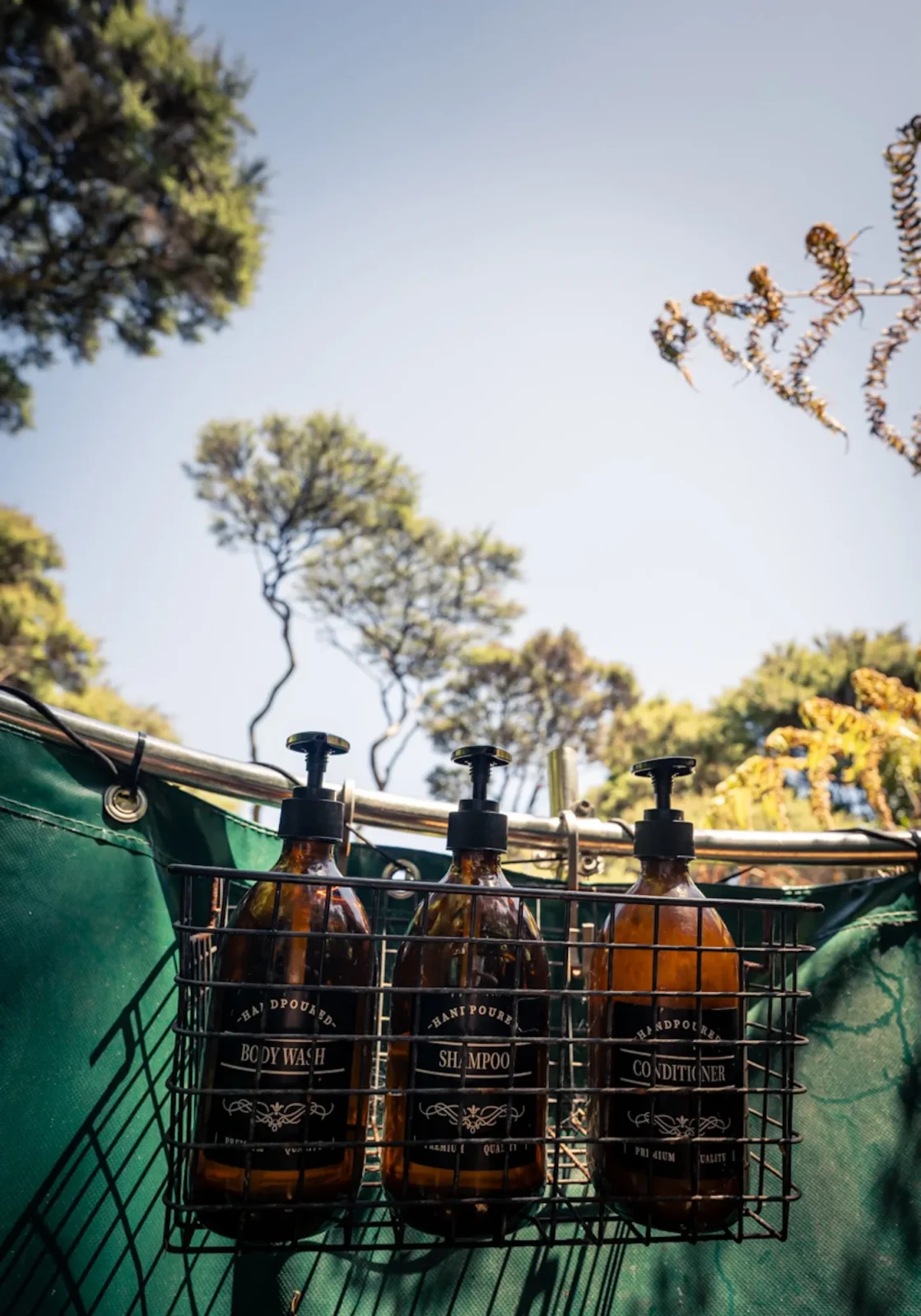Shampoo bottles inside the outdoor shower at Totara Enclave
